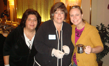 Three volunteers greeting arrivals