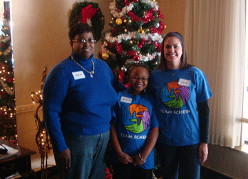 Volunteers in team shirts by the tree