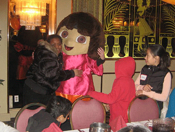 Children hugging a costumed character