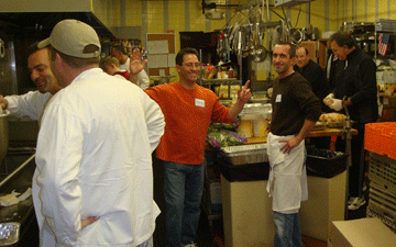 Kitchen crew laughing between courses