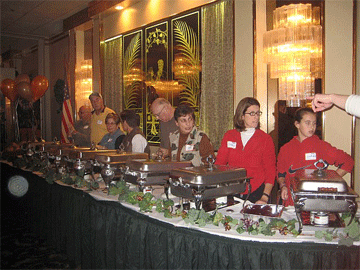 Volunteers behind a full buffet line