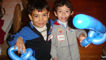 Two boys holding balloon animals