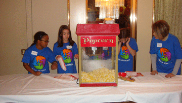 Young volunteers running the popcorn machine