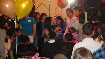 Children gathered around a balloon artist