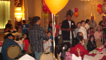 Guests gathered around tables with balloons