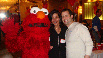 Volunteers with a red costumed character